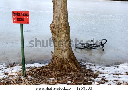 bike on an iced lake in  in a village in denmark with a sign \