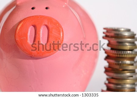 money coins in a pile with money box, piggy bank