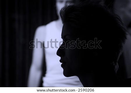 nightlife : woman outdoor in a  city  on shopping tour,  profile of her passing by a shop with man model