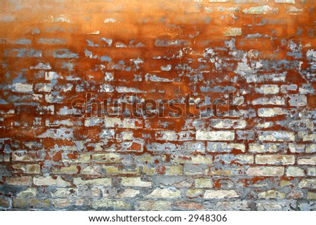 old wall of a house partly  in brick in orange colour