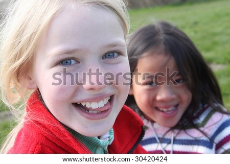 Close up of face of happy children while smiling /laughing and playing together