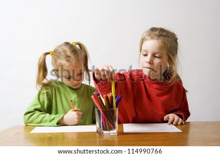 Children drawing with markers on the grey background