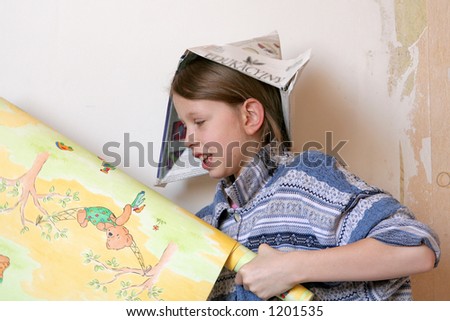 Young girl wallpapering