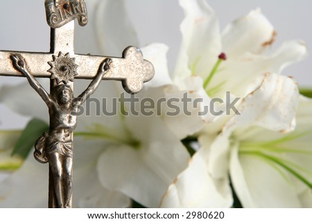 Old cross on white easter lilies background