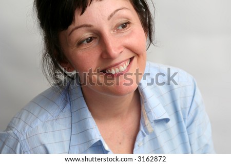 stock photo Beautiful mature brunette woman wearing blue shirt