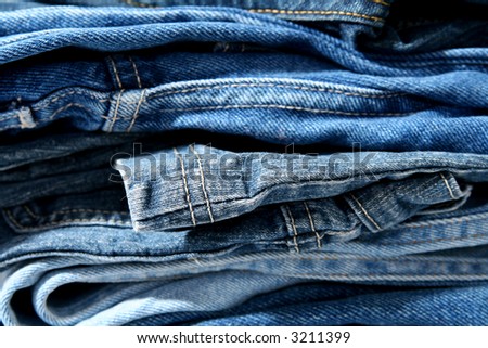 Pile of trausers made of blue denim jeans