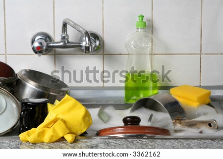 Pile of dirty dishes in the metal sink