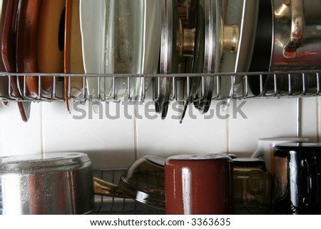 Wet dishes drying on the metal plate rack