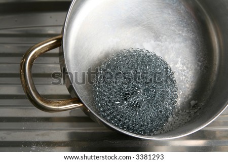 Metal pot cleaning with  wire wool and powder