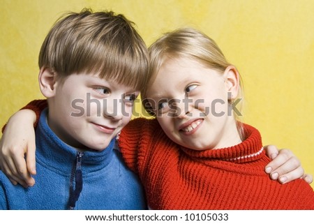 Portrait of happy children on a yellow background