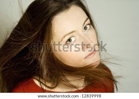Beautiful woman with long dark hair wearing red blouse