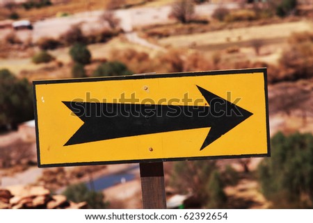 black arrow on a yellow background