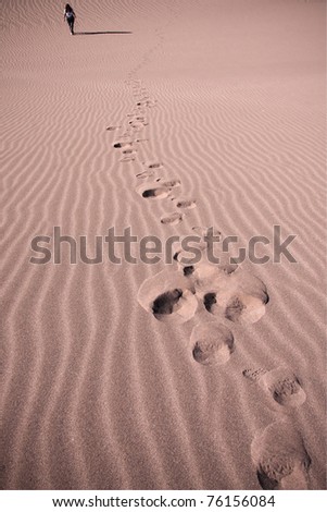 woman walking on sand dunes in atacama desert in chile