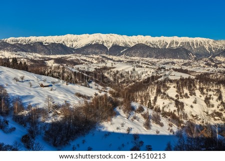 a beautiful winter landscape with a mountain village. Village Pestera , Bran, Romania