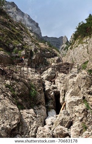 a tourist who climb a mountain valley, Bucegi Mountains, Romania