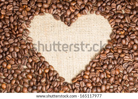 Heart coffee frame made of coffee beans on burlap texture