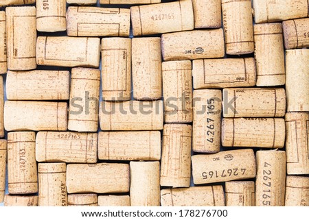 Closeup of a wall of used wine corks. A random selection of used wine corks, some with vintage years. Horizontal format that fills the frame.