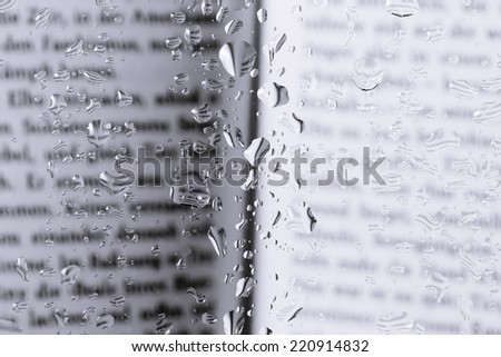 book behind the glass with drops