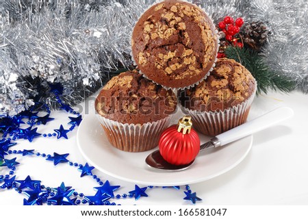 three chocolate cake and christmas ball in a spoon on a plate