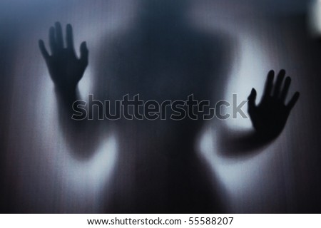 Female Silhouette photographed through a dark glass