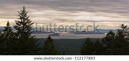 A beautiful panorama of the San Juan Islands, in northwest Washington, on an overcast afternoon.  Canada\'s Vancouver Island is visible in the distance.