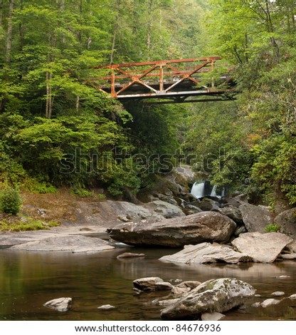 Old rusted iron bridge in the Appalachian Mountains.  This bridge crosses the Chattooga near Highlands, North Carolina