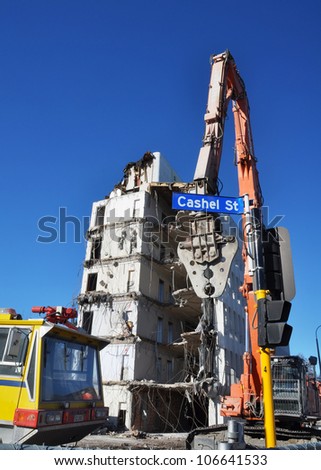 CHRISTCHURCH, NEW ZEALAND - MAY 20: Powerful equipment being used to tear down earthquake damaged high rise buildings on May 20, 2012 in Christchurch.