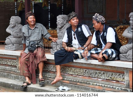 BALI, INDONESIA - OCTOBER 07: Balinese men at a religious festival in Celuk. They are wearing traditional religious black and white (Hindu evil & good spirits) fabric. on October 07,2011 in Bali.
