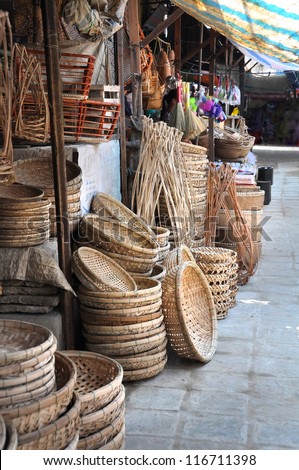 Cane basket and tray craft shop at the Hoi An market, Vietnam.