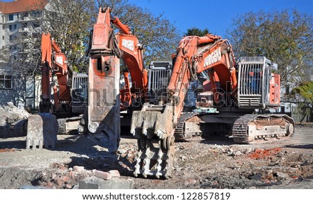 CHRISTCHURCH, NEW ZEALAND - MAY 21, 2011: Three machines of mass destruction  designed to tear down buildings, cut steel reinforcing and scoop up the debris on May 21, 2011 in Christchurch.