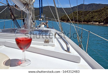Summer Luxury - a glass of Rose on the deck of a yacht in the Marlborough Sounds, New Zealand.