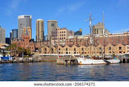 Sydney, Australia - July 18, 2014: Historic sailing ship moored at Circular Quay with the Rocks & CBD restaurants & buildings in the background.