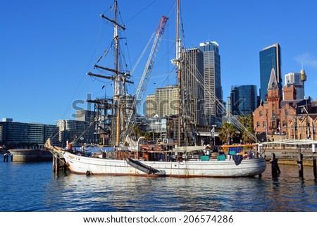 Sydney, Australia - July 17, 2014: Historic sailing ship moored at Circular Quay with the Rocks & CBD buildings in the background.