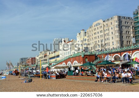 Brighton, United Kingdom - September 28, 2014: A busy lunchtime crowd on a summer day at the restaurants on Brighton Beach.