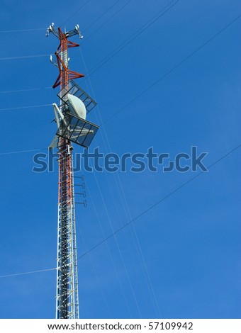 Cellular Tower against a Blue Sky with open space to the right