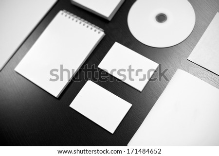 Blank stationery set on black wood background / business cards, disk, envelope, booklet, notepad