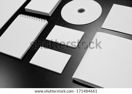 Blank stationery set on black wood background / business cards, letterheads, disk, envelope, booklet, notepad