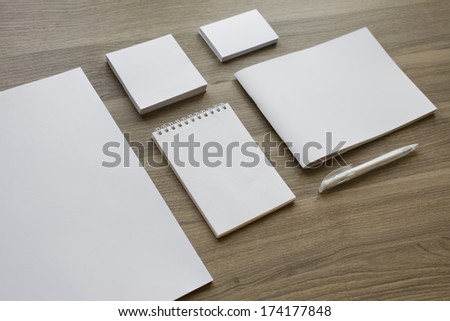 Blank stationery set on wood background / a4 paper, business cards, letterheads, booklet, notepad and pen