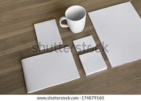 Blank stationery set on wood background / a4 paper, business cards, letterheads, booklet, notepad and cup