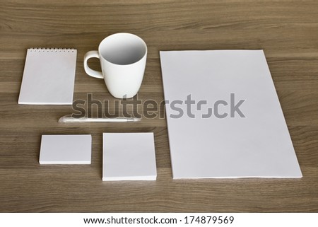 Blank stationery set on wood background / a4 paper, business cards, letterheads, booklet, notepad and cup
