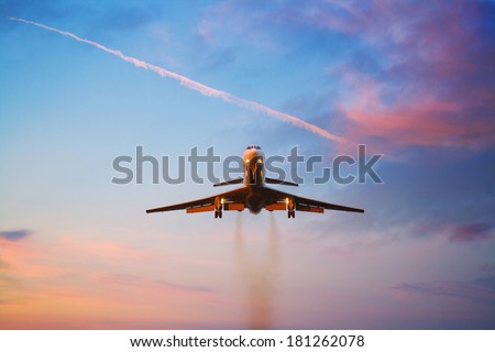 Photo of an airplane at sunset
