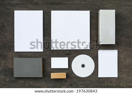 Blank stationery set on wood background: business cards, booklet, sheets, notebook, stamp, CD, and and old boxes (for branded souvenirs).