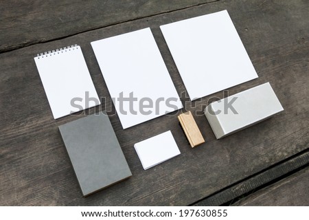 Blank stationery set on wood background: business cards, booklet, sheets, notebook, stamp, and and old boxes (for branded souvenirs).