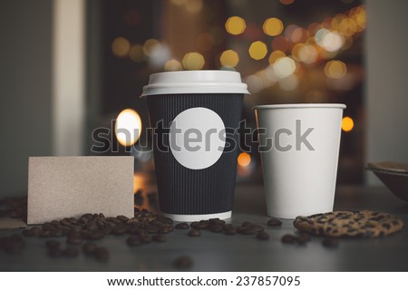 Photo blank paper cup of coffee and business card coffee shop to apply logo