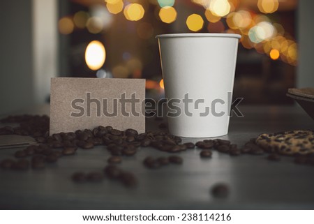 Photo blank paper cup of coffee and business card coffee shop for the application logo