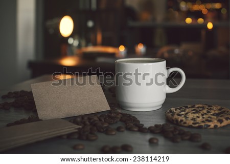 Photo a cup of coffee and blank business card for the application logo