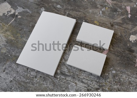 Blank business cards (two stacks) and booklet on a wooden grunge texture