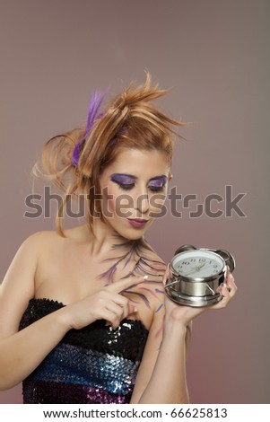 Female model holding clock in hand.. Times up!!