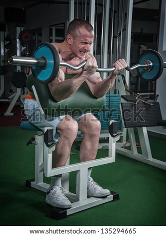 Muscular Man Doing Heavy Barbell Exercise