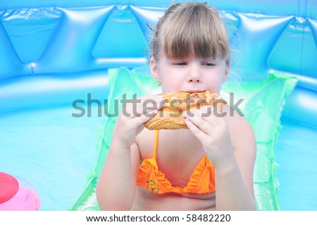 Girl eating biscuits in the pool
